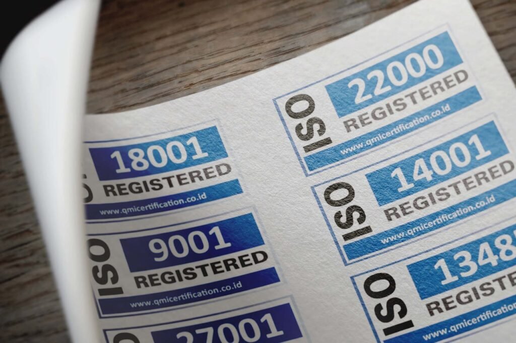 pexels photo 12324202 ISO certification stickers with registration numbers on paper.