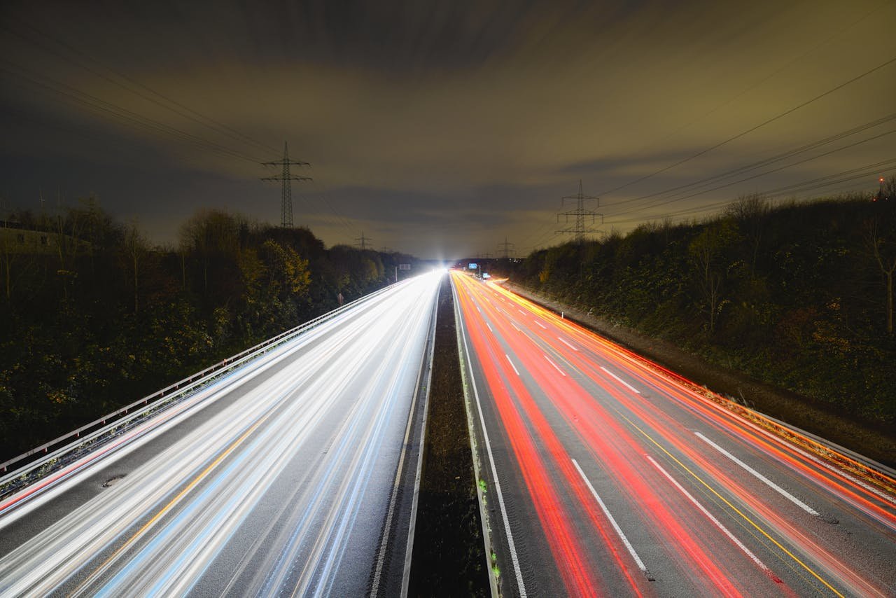 creative-01 Captivating long exposure photo showcasing dynamic light trails on a nighttime highway.